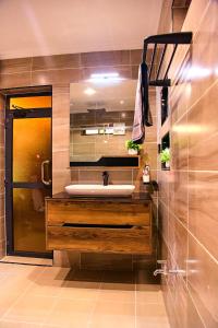 a bathroom with a sink and a mirror at Bhai Apartments in Mwanza