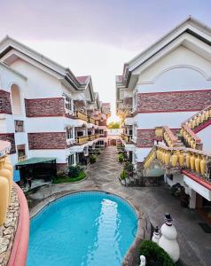 an overhead view of a swimming pool in front of a building at Casablanca Hotel Condominium Resort in Olongapo