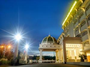a building with a gazebo in front of it at New Palace Bac Lieu Hotel in Bạc Liêu