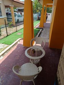 two chairs and a table on a patio at FAs KLIA Guesthouse, 4BR 4 AC , NEAR KLIA, NILAI in Sepang