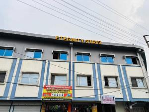 a building with a sign on top of it at Hotel O Eternity Stays in Rao +4 photos