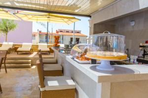 a buffet line with a pie in a glass container at Luxury Aparthotel in Makarska