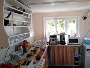 a kitchen with a cluttered counter top with appliances at Odyssey Guest House in Bergama