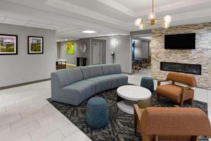 a living room with a couch and a fireplace at La Quinta by Wyndham Lexington South / Hamburg in Lexington