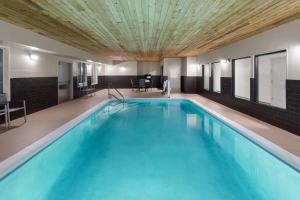 a large swimming pool in a building with a ceiling at La Quinta by Wyndham Lexington South / Hamburg in Lexington