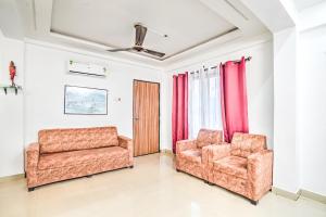 two chairs and a couch in a living room at Villa Bliss by Palette Homes Lonavala in Lonavala