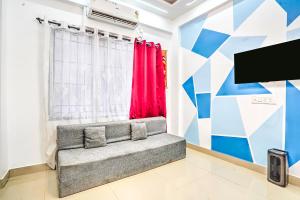 a living room with a couch and a tv at Villa Bliss by Palette Homes Lonavala in Lonavala