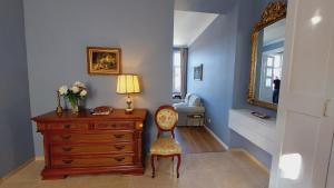 a room with a dresser and a chair and a mirror at Castle View in Budapest