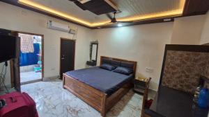a bedroom with a bed and a tv in it at 2BHK Home fully furnished at Sahid Nagar near INOX in Bhubaneshwar