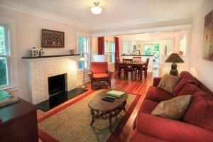 a living room with a red couch and a fireplace at Mango Haus 2bd 2ba Private Pool and Parking in West Palm Beach