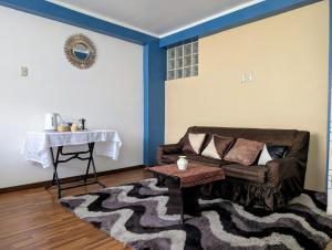 a living room with a couch and a table at MONOAMBIENTE Sicuani in Sicuani