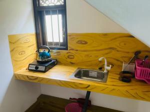 a wooden counter top with a sink and a window at New Jaya Villa in Bentota