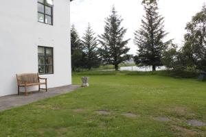 a bench sitting in a yard next to a building at Guesthouse Hraunbaer in Aðaldalur