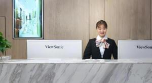 a woman in a suit sitting at a counter with two laptops at GreenTree Inn Express Hebei Shijiazhuang Zhengding County Changshan Dong Road in Shijiazhuang