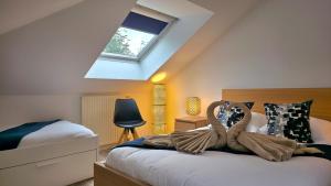 a bedroom with a bed with two swans on it at Akela - Appartement à 12mn de Disneyland Paris ! in Bussy-Saint-Georges