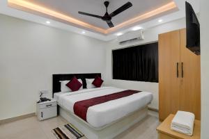 a bedroom with a large bed with a ceiling fan at Hotel Royal Place in Kolkata +21 photos