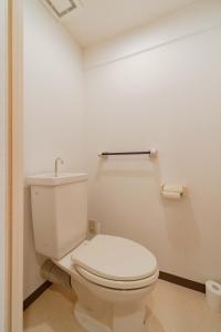 a bathroom with a white toilet in a room at Minami-Ohashi Good Place House in Fukuoka