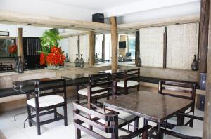 a restaurant with tables and chairs in a room at Hotel Maya Rue in Palenque