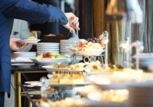 a buffet with plates of food on a table at Marco Polo Dhaka in Dhaka