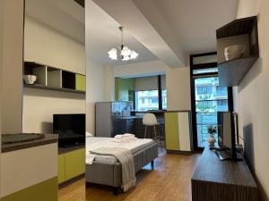two pictures of a room with a bed and a kitchen at Studio near Copou Hospitals IRO Parhon in Iaşi