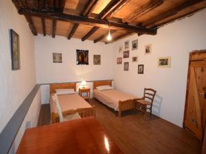 a bedroom with two beds and a table and chairs at Eftopia Martino Pansion in Martínon