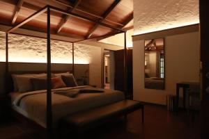 a bedroom with a large bed in a room at Aelam Acres in Chillithodu