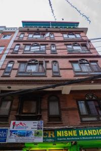a tall brick building with windows on top of it at Holiday Hostel in Kathmandu