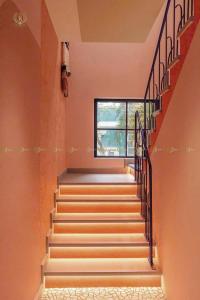 a set of stairs in a house with a window at MYSTERY HOME - NOVAWORLD PHAN THIET 3BR 120m2 in Bình Tú