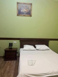 a bedroom with a bed with a picture on the wall at Hotel 365 in Zvartnots International Airport +20 photos
