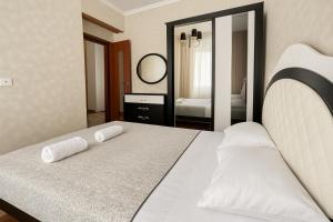 a bedroom with a bed with two pillows on it at Your Home Inn at Jikia's Green House-Central Tbilisi in Tbilisi City