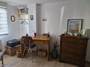a desk with a chair and a dresser in a room at Ananda in Le Mans