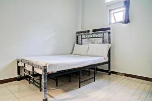 Postel nebo postele na pokoji v ubytování Hotel O Penginapan Hj Lilis 2 Syariah + 46 fotografií