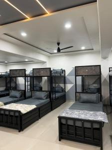 a room with four bunk beds in it at Royal Dormitory in Jālgaon