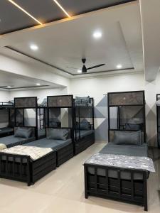 a room with four bunk beds in it at Royal Dormitory in Jālgaon +3 photos