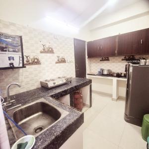 a kitchen with a sink and a counter top at Awesome 3bhk apartment in Hyderabad
