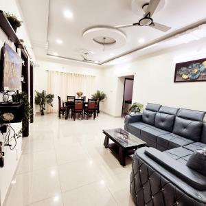 a living room with a couch and a table at Awesome 3bhk apartment in Hyderabad