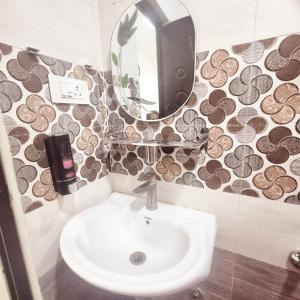 a bathroom with a sink and a mirror at Awesome 3bhk apartment in Hyderabad +5 photos