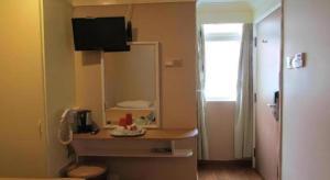 a small room with a table and a mirror at Arianna Hotel in Singapore