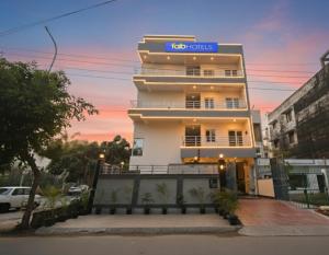 a building with a sign on top of it at Via Palm Paradise in Noida