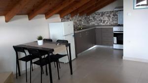 a kitchen with a table and chairs and a refrigerator at Villa Eleni in Ofrínion