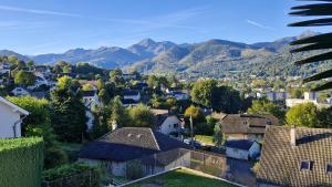 a small town with mountains in the background at Maison rayons de soleil in Bagnères-de-Bigorre