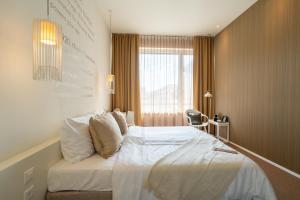 Una cama o camas en una habitación de Trafo Hotel Baden 27 fotos más