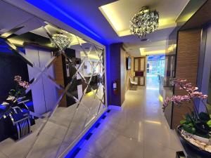 a hallway with purple lighting and a lobby at Masters Suites Hotel in Makkasan