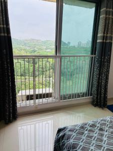 a bedroom with a large window with a view at 2bhk in mumbai spacious in Mumbai