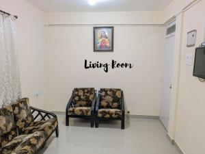 a living room with two chairs and a couch at Newly Renovated 2BHK in Margao in Madgaon