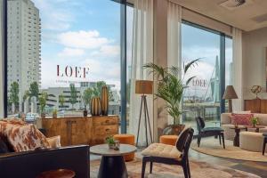 a living room with a view of a city at Haven Hotel Rotterdam, Curio Collection by Hilton in Rotterdam