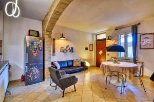 a living room with a table and a refrigerator at InCorteDaFabio Design flat with Bikes in Caronno Pertusella