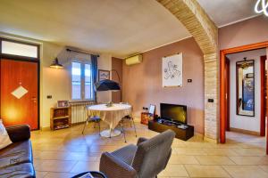 a living room with a table and a tv at InCorteDaFabio Design flat with Bikes in Caronno Pertusella