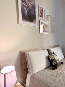 a bedroom with a couch and a table and pictures on the wall at Favola Guesthouse Affittacamere in Nettuno