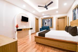 a bedroom with a bed and a flat screen tv at Palette by CheckIn Shree Jagannath Puri in Puri +33 photos